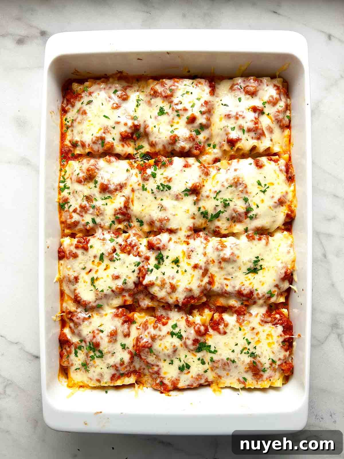 lasagna roll ups done baking in baking dish; parsley sprinkled on top.