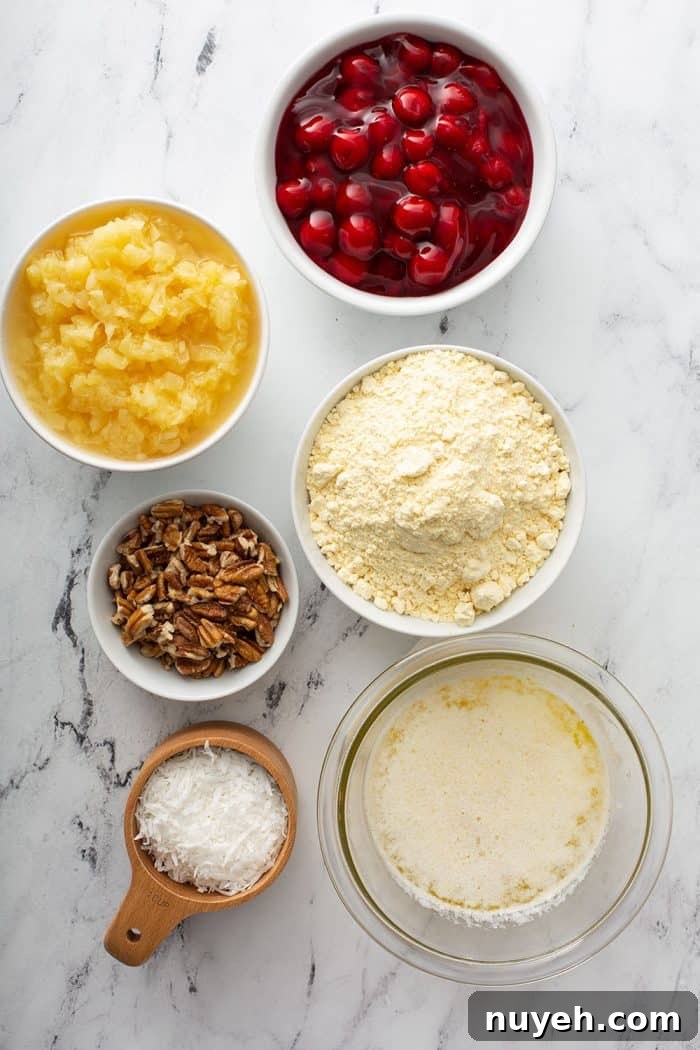 Ingredients for cherry pineapple dump cake on a marble countertop
