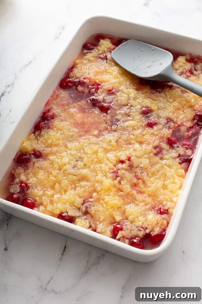 crushed pineapple and cherry pie filling layered in a cake pan