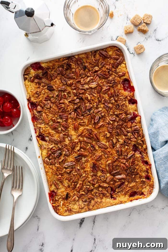 Baked cherry pineapple dump cake in a white cake pan
