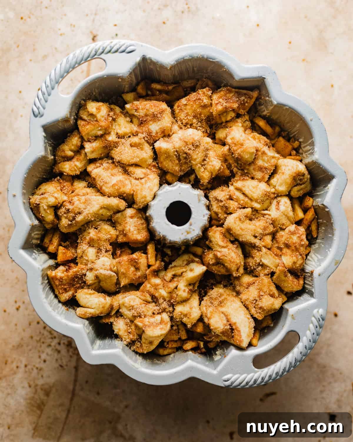 apple cider monkey bread assembled in a bundt pan.