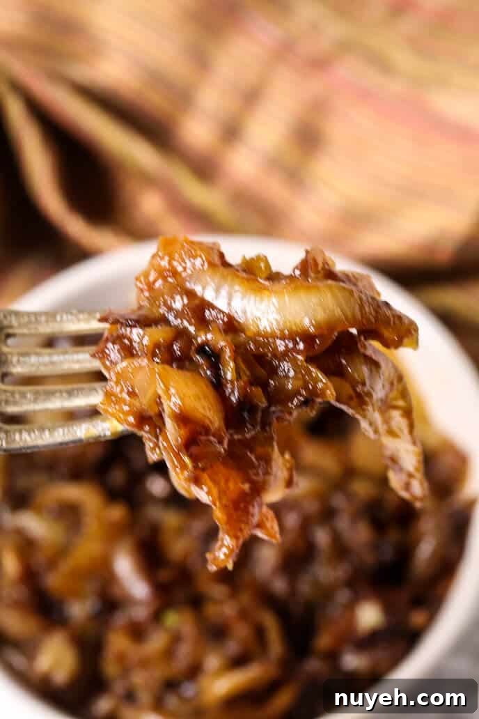 Carmalized onions on a fork from round white dish