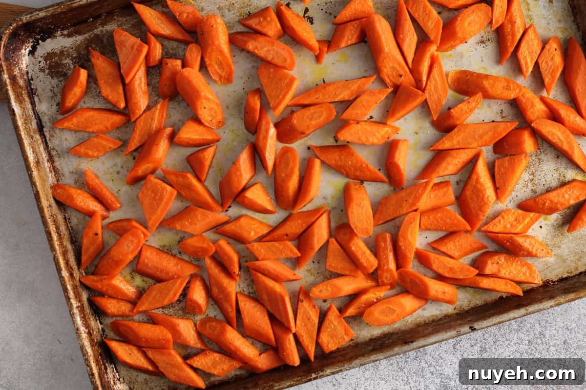 cut roasted carrots on baking sheet