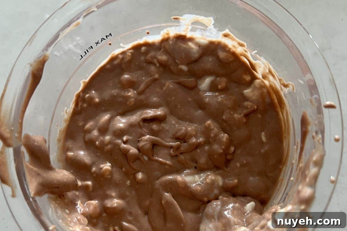 Ninja Creami pint being filled with chocolate milk
