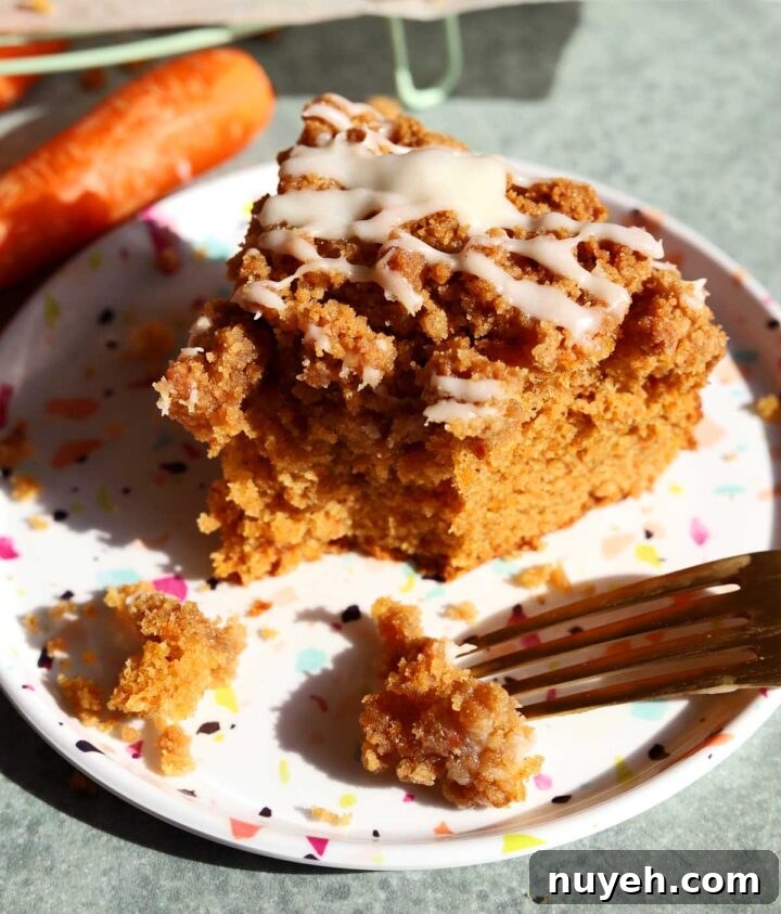 carrot cake coffee cake slice on a plate with bite and fork