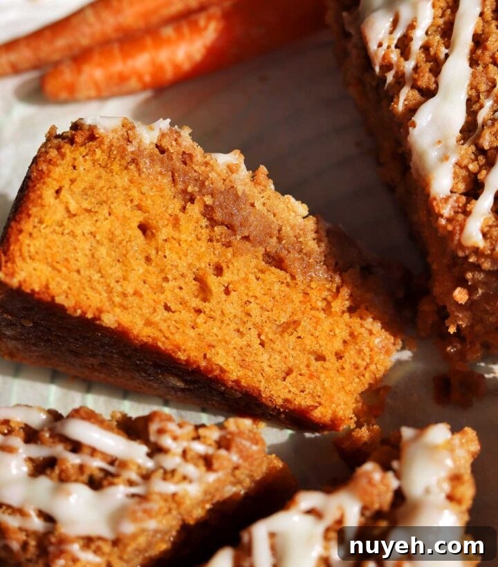 carrot cake coffee cake sliced on parchment paper