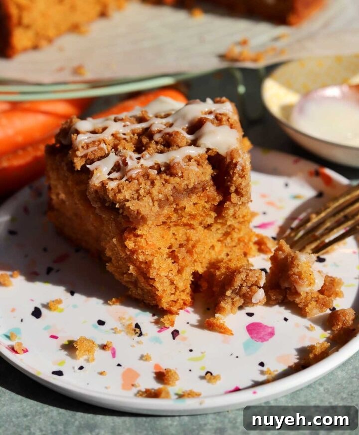 carrot cake coffee cake slice on a plate with bite and fork