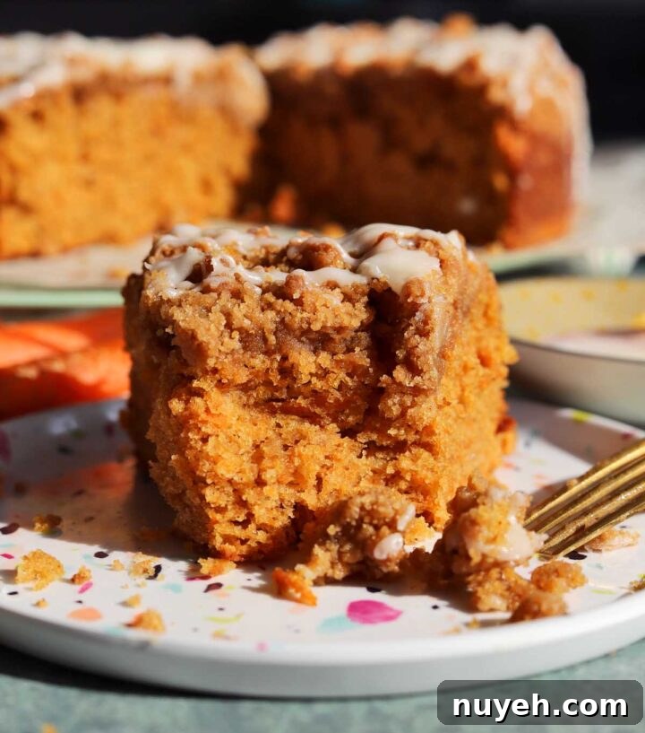 carrot cake coffee cake slice on a plate with bite and fork