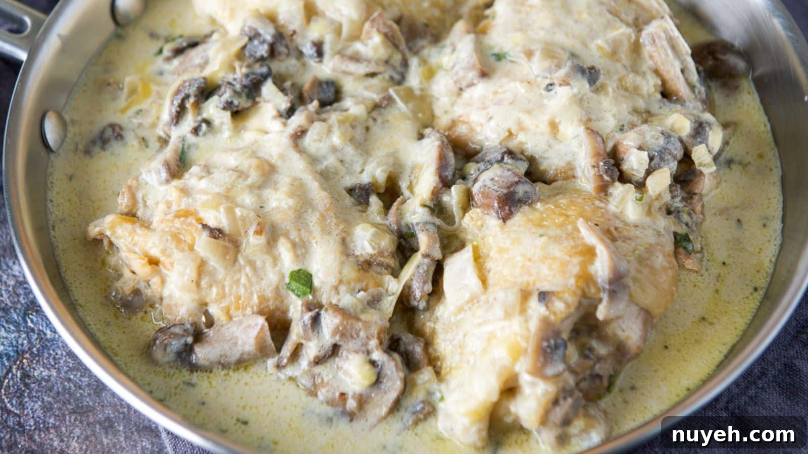 A pan of chicken thighs in a cream sauce
