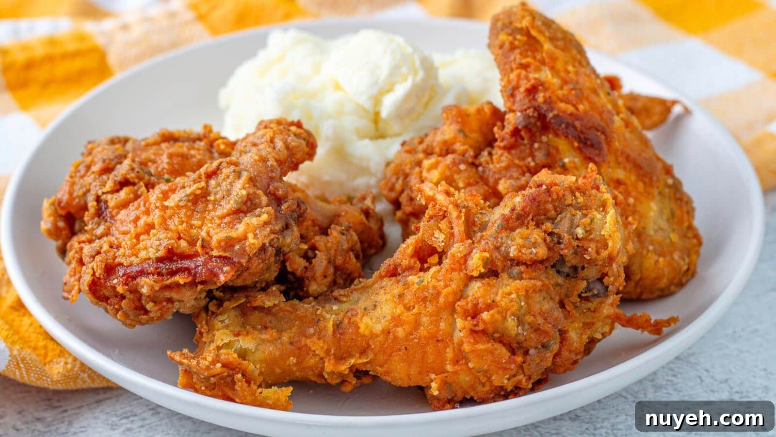 a plate with pieces of fried chicken and potatoes on it