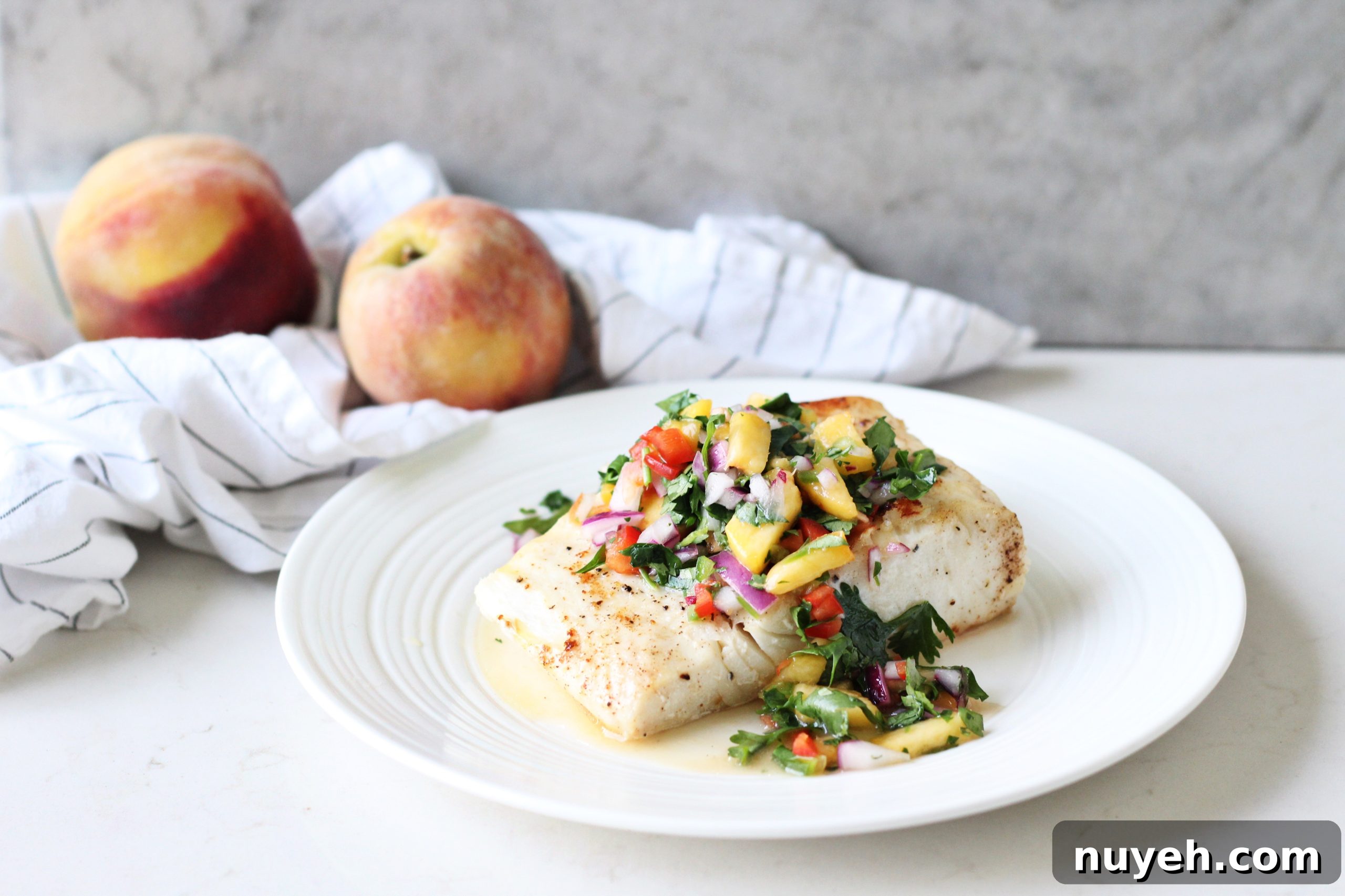 Halibut with Mango Salsa & Coconut Rice on white plate