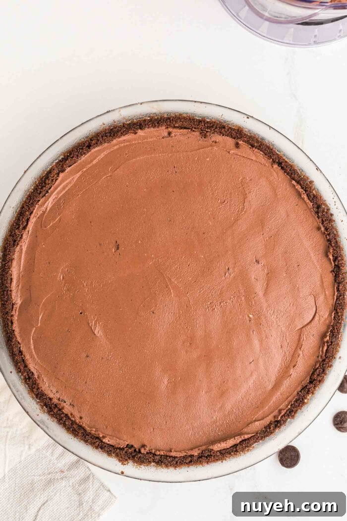 Overhead view of a chocolate pie with chocolate pie crust in a glass pie dish.