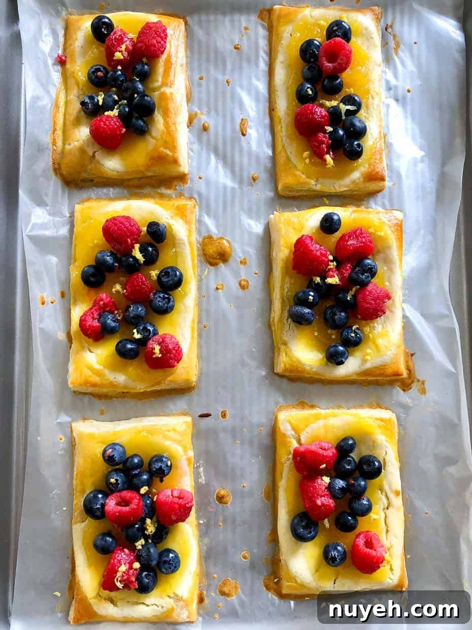 Lemon and berry cheesecake puffs on baking sheet 