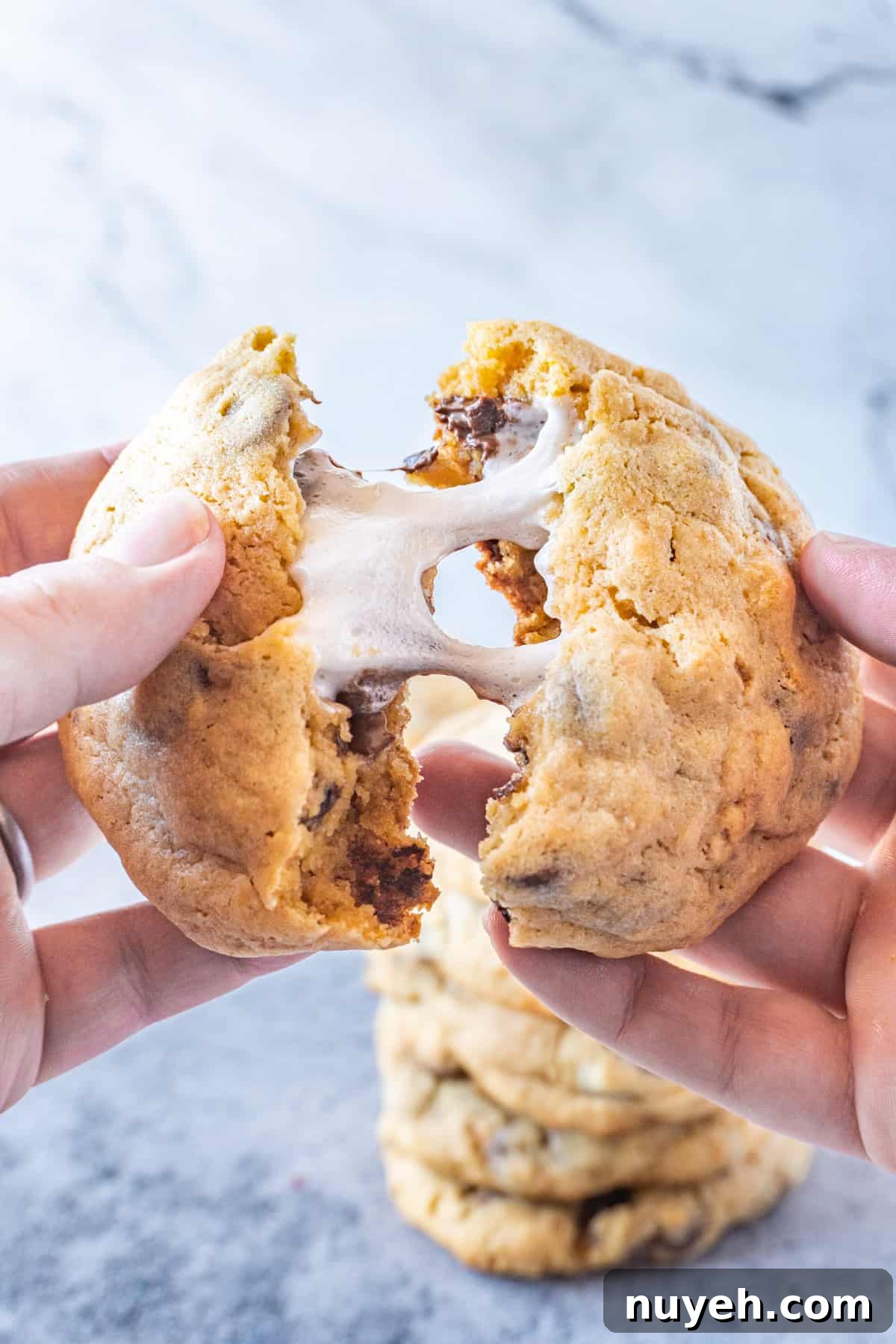pulling apart a marshmallow stuffed cookie