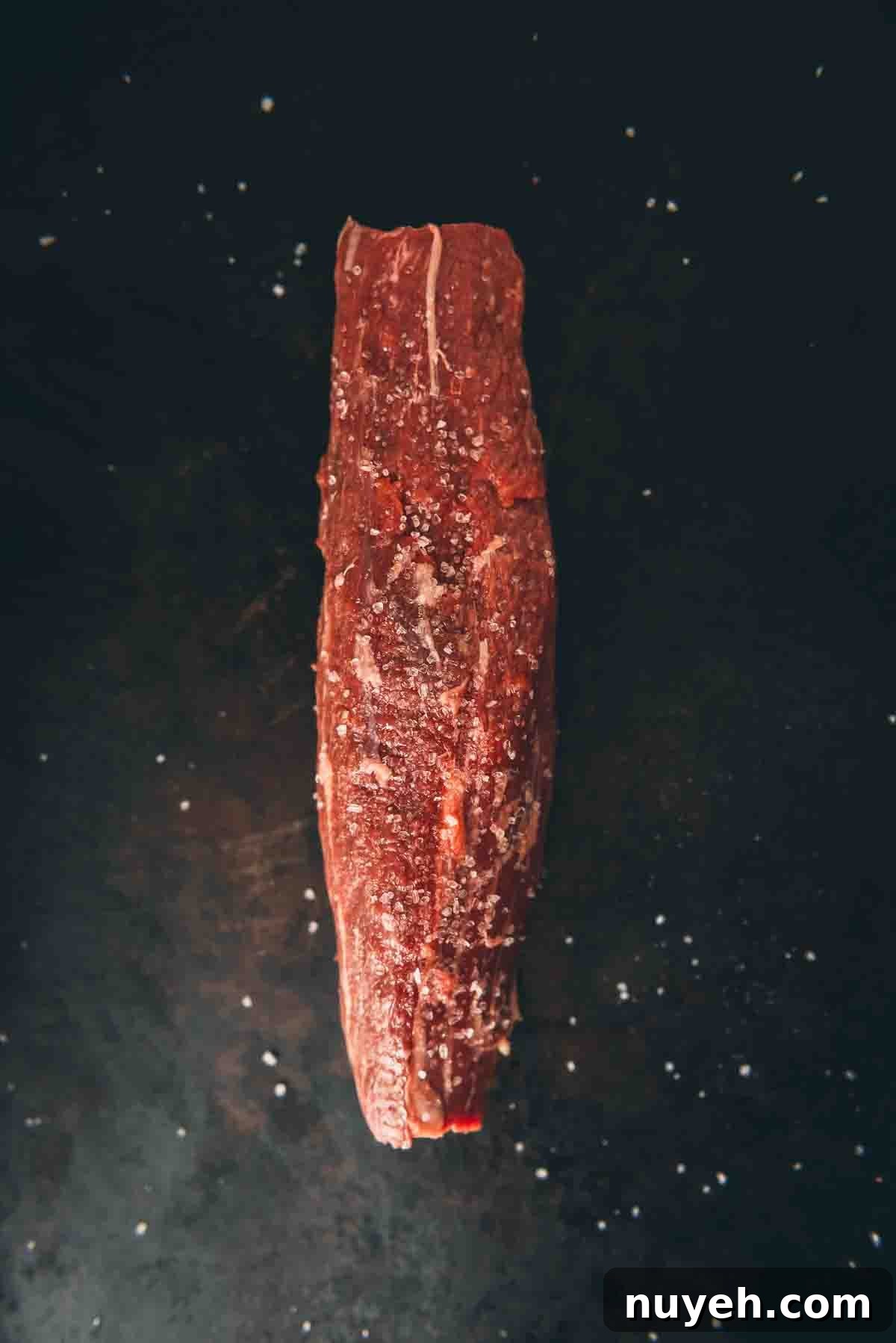 Teres major steak seasoned with salt. 