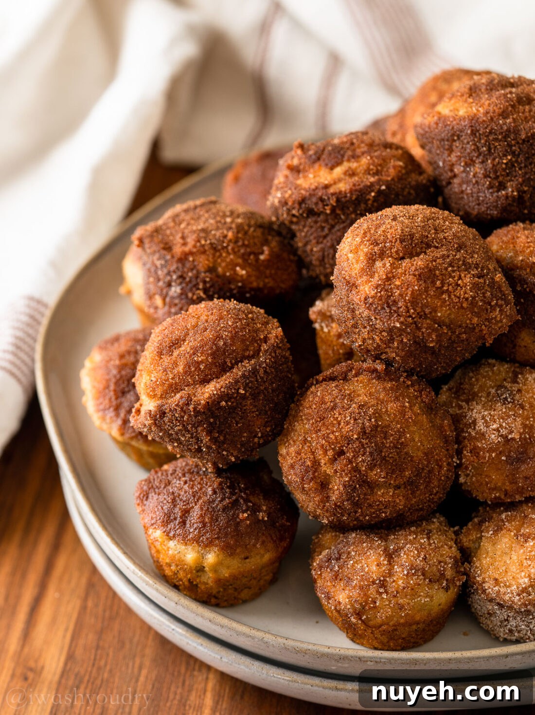 Plate of mini muffins with white towel in the background.