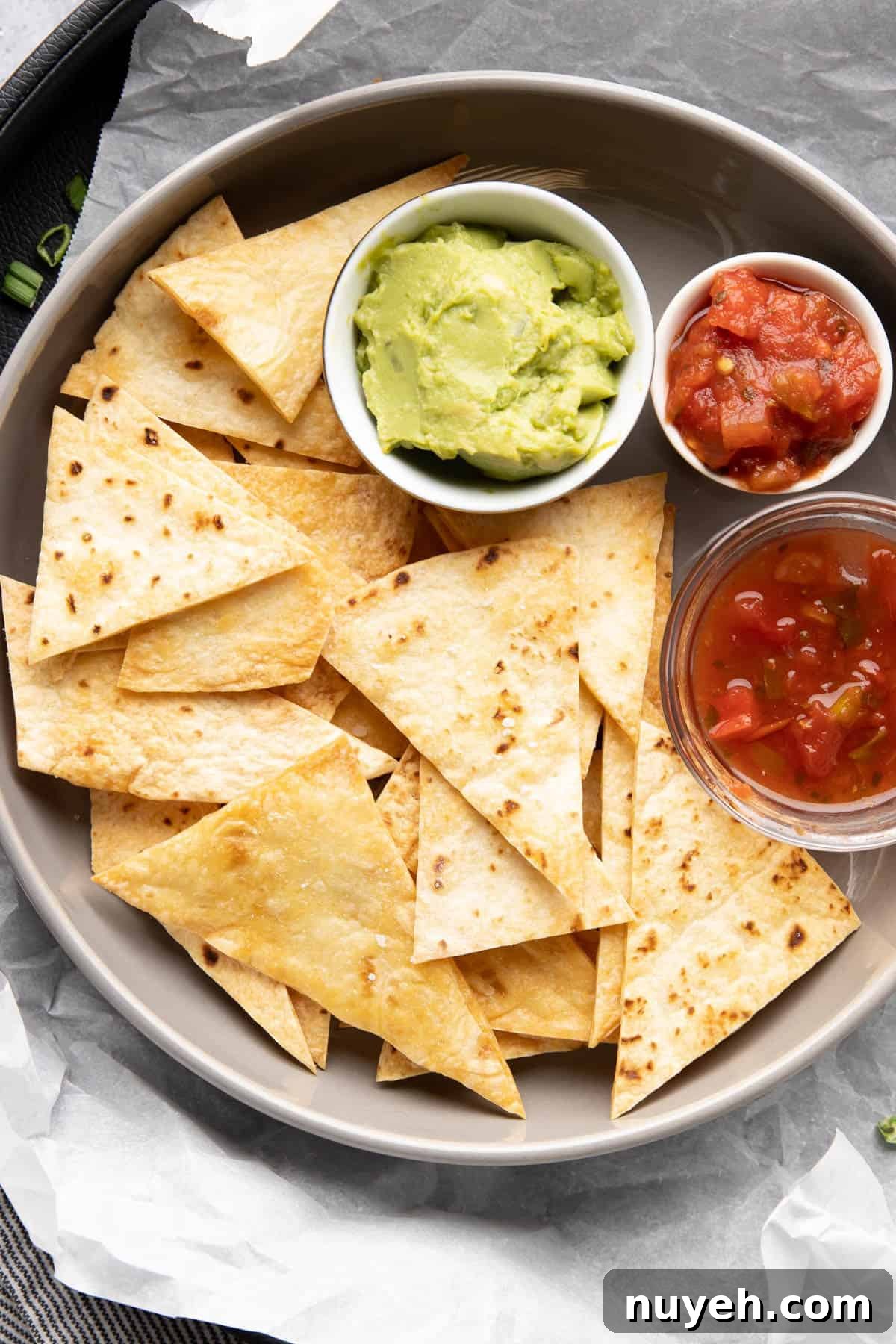 Crispy Homemade Baked Tortilla Chips 2 Plate full of baked tortilla chips and assorted dips