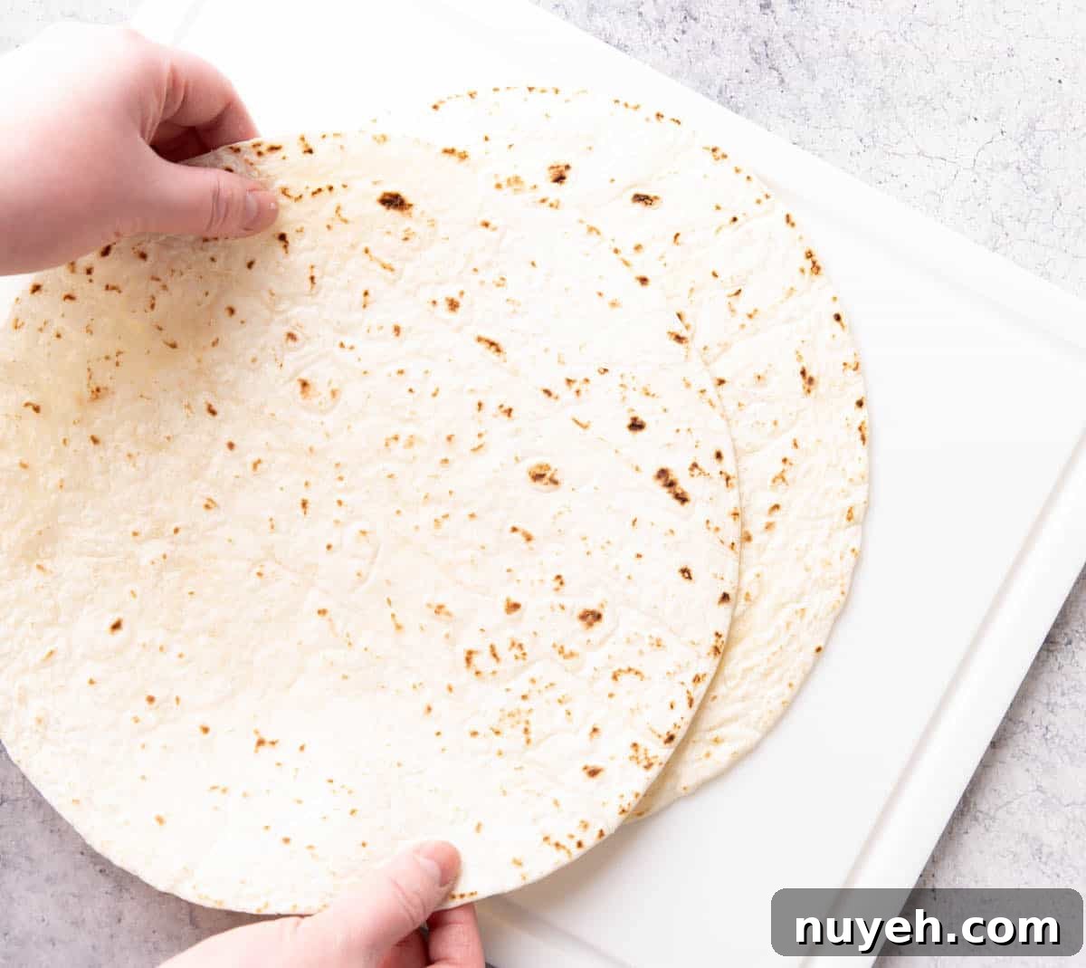 Crispy Homemade Baked Tortilla Chips 4 Photo showing How to Make Baked Tortilla Chips – stacking tortillas on a cutting board
