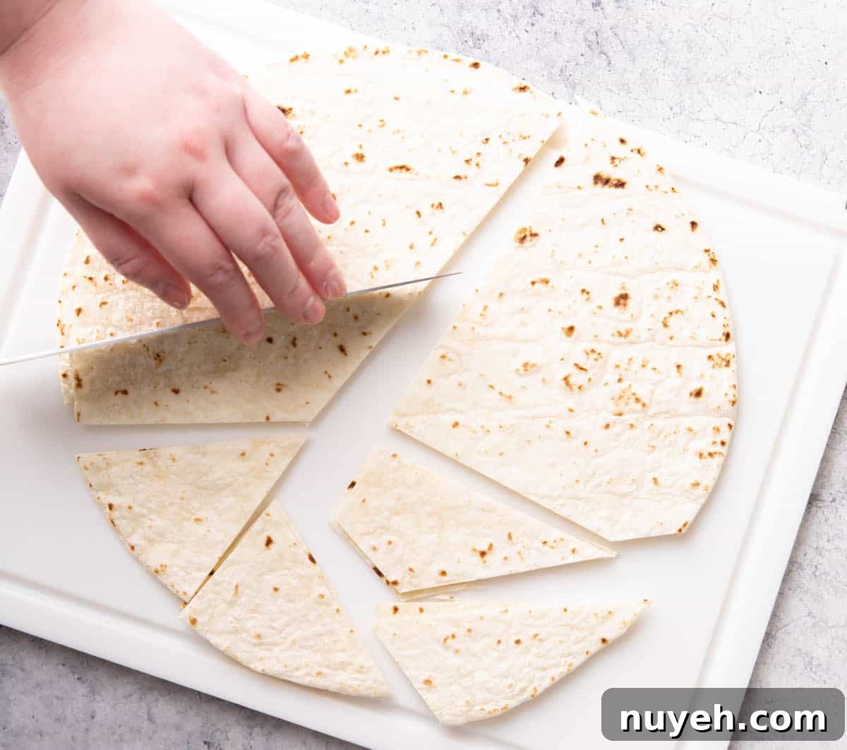 Crispy Homemade Baked Tortilla Chips 5 Photo showing How to Make Baked Tortilla Chips – slicing tortillas into chips