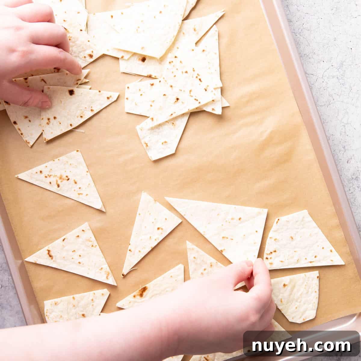 Crispy Homemade Baked Tortilla Chips 6 Photo showing How to Make Baked Tortilla Chips – laying tortilla chips on baking sheet
