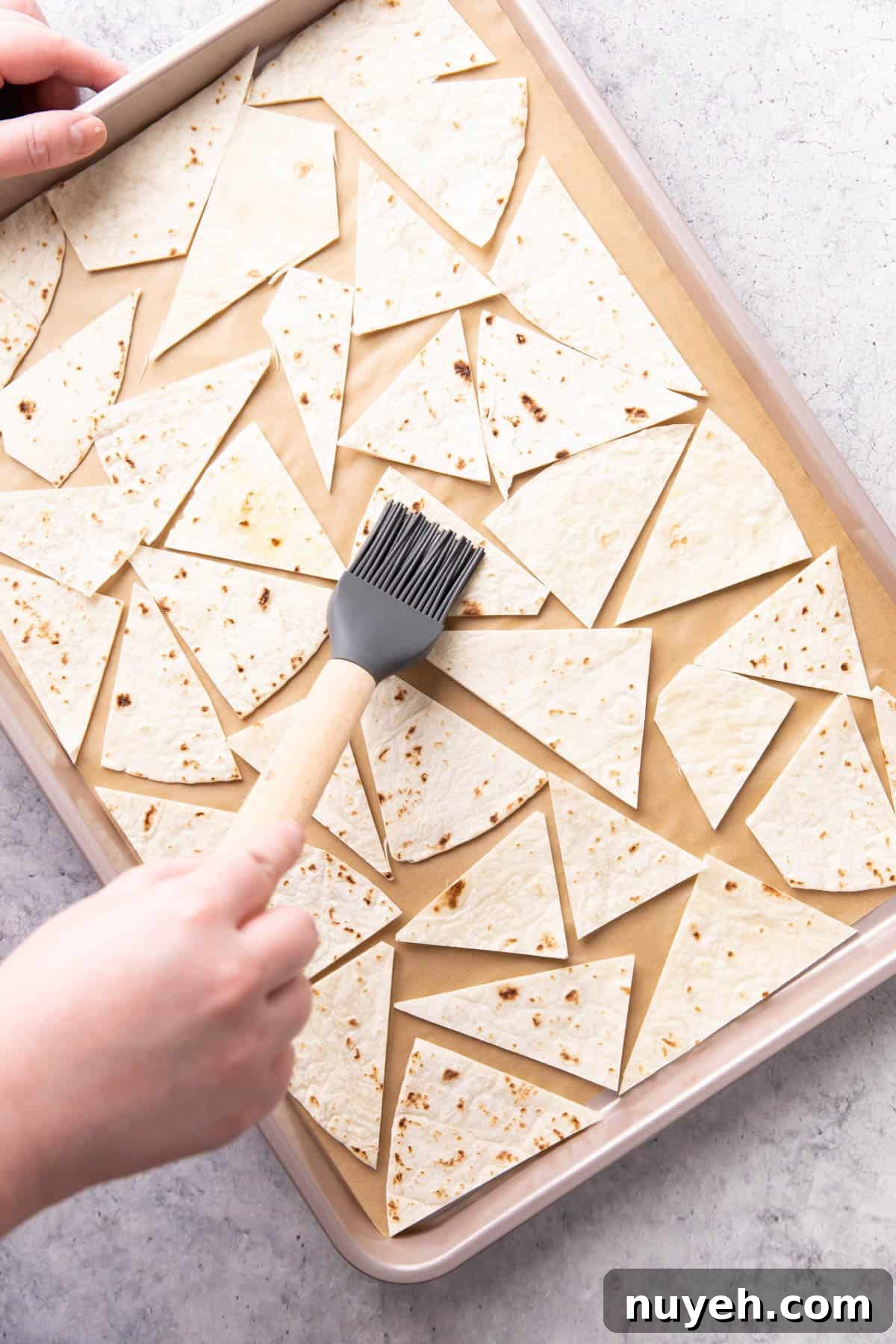 Crispy Homemade Baked Tortilla Chips 7 Photo showing How to Make this recipe – brushing oil onto chips