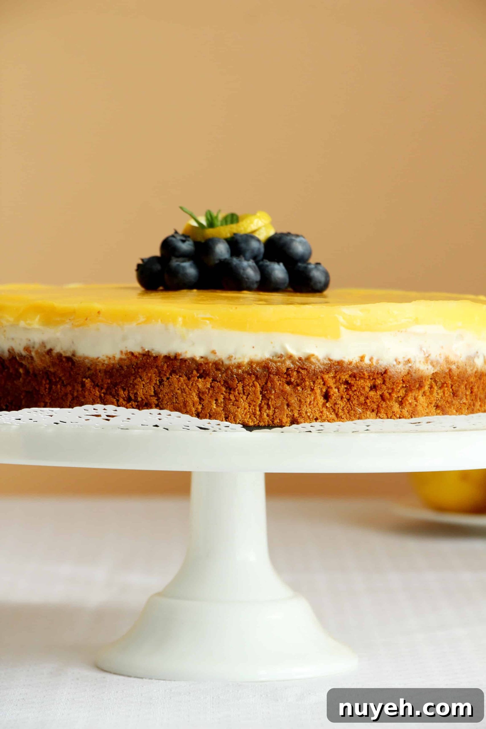 lemon cheesecake on white cake stand