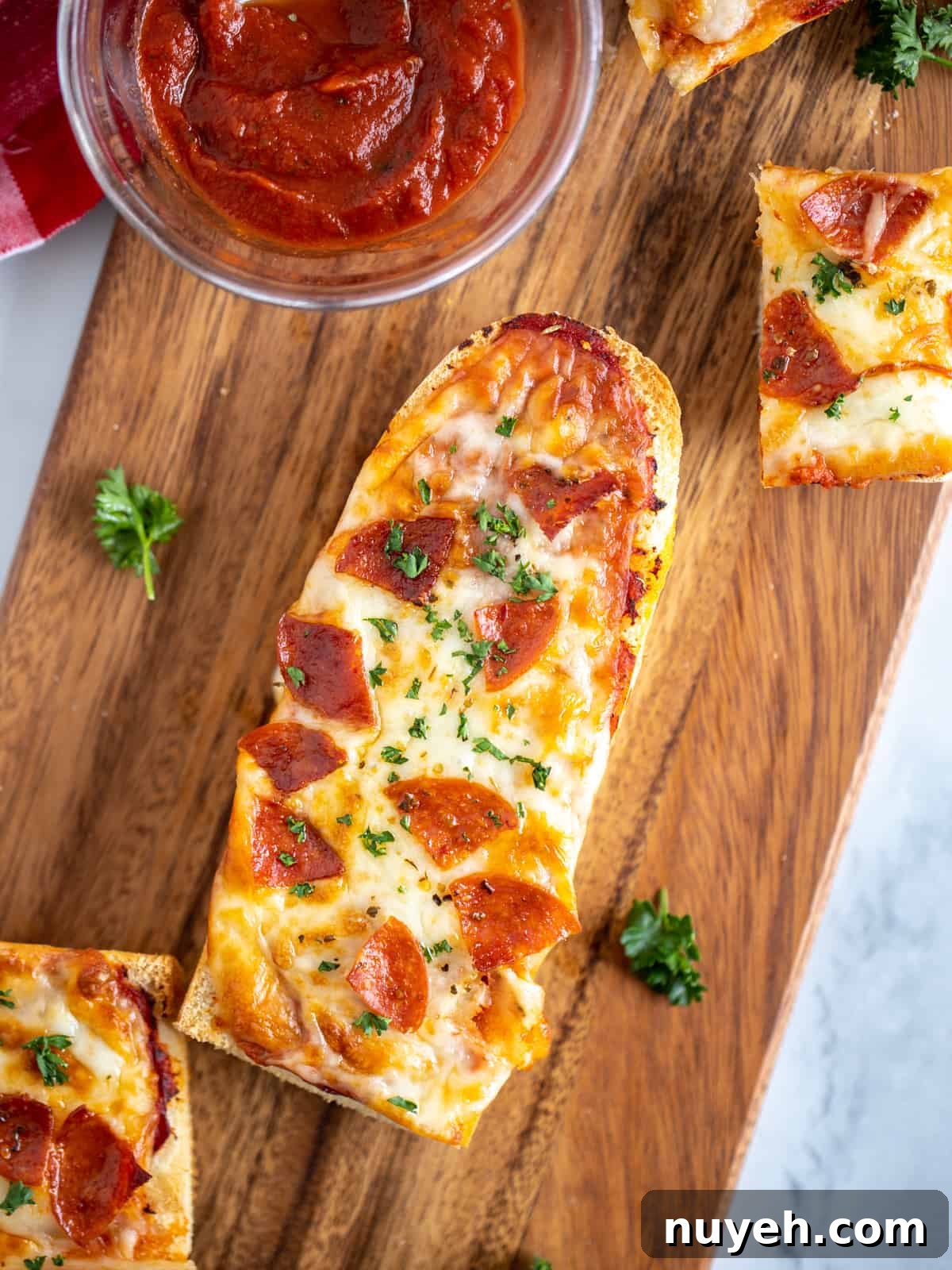 Air Fryer French Bread Pizza with Pepperoni on cutting board after being cooked.