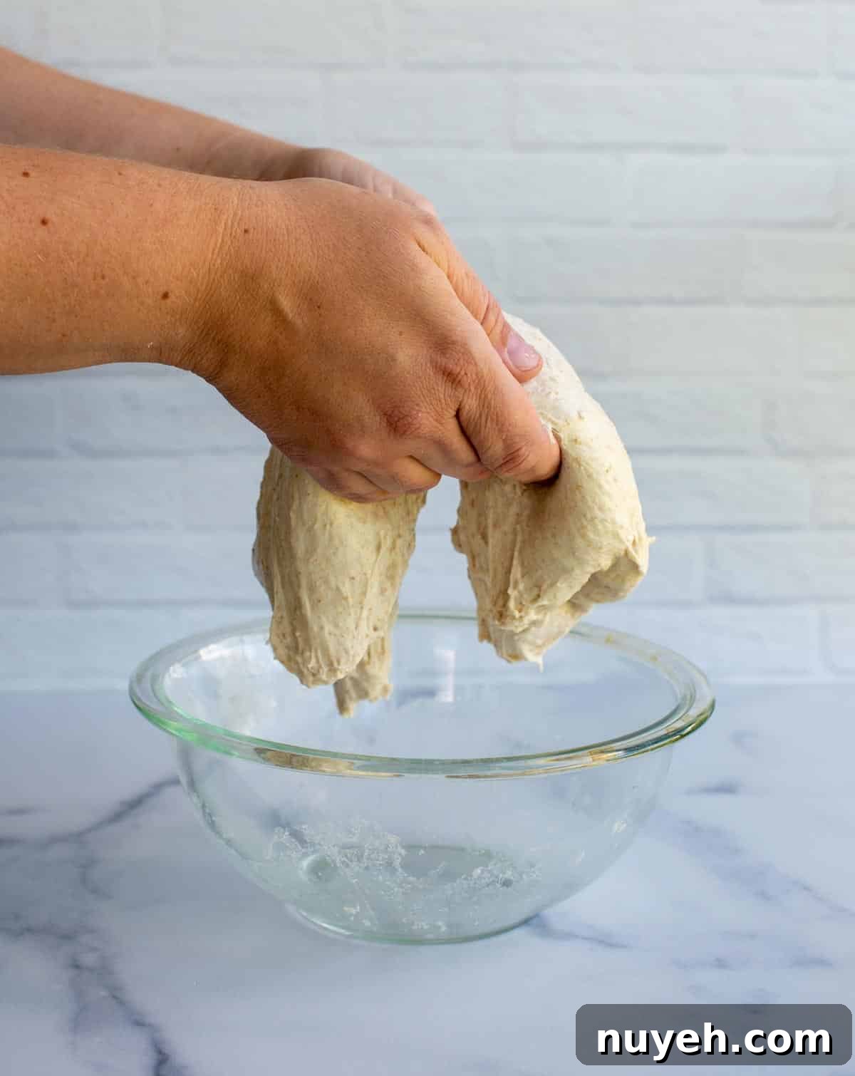 Coil Folds with dough in a bowl.
