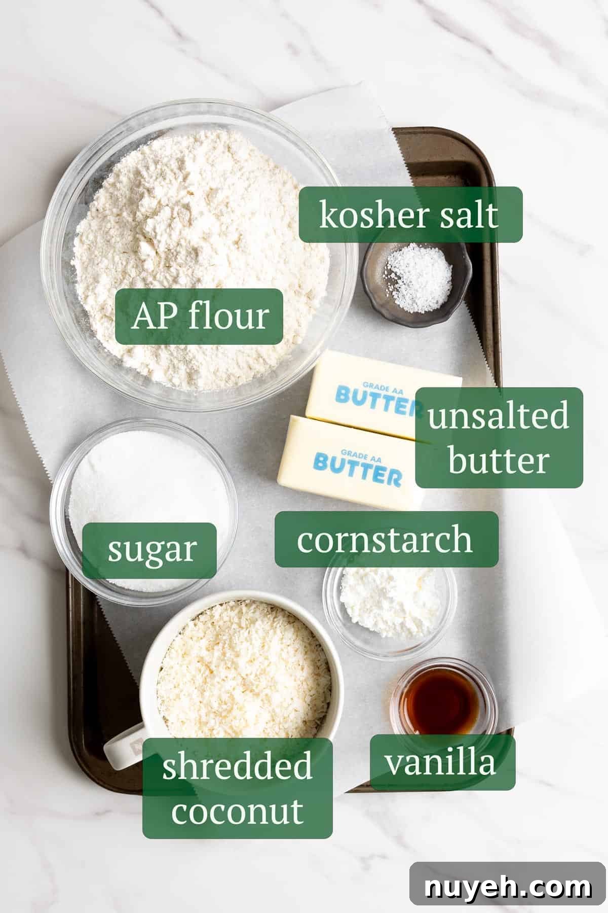 Ingredients for coconut shortbread cookies on a baking tray.