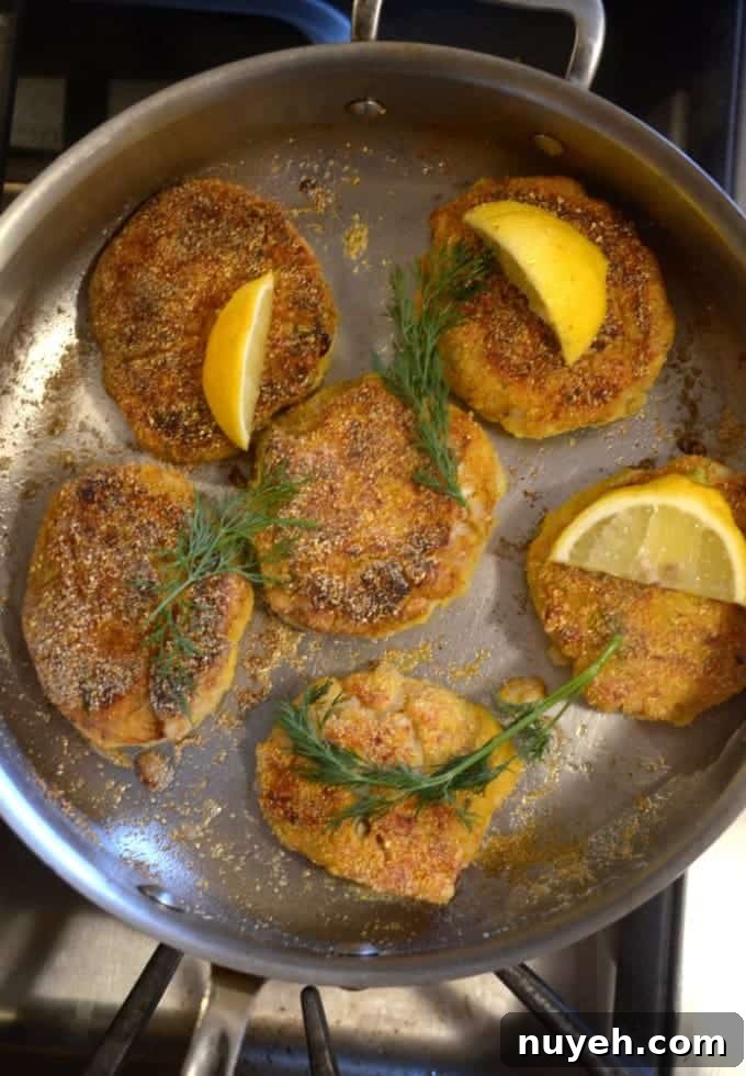 A bunch of fish cakes in a pan.
