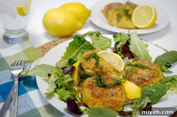 A plate of fish cakes sitting on a bed of lettuce.