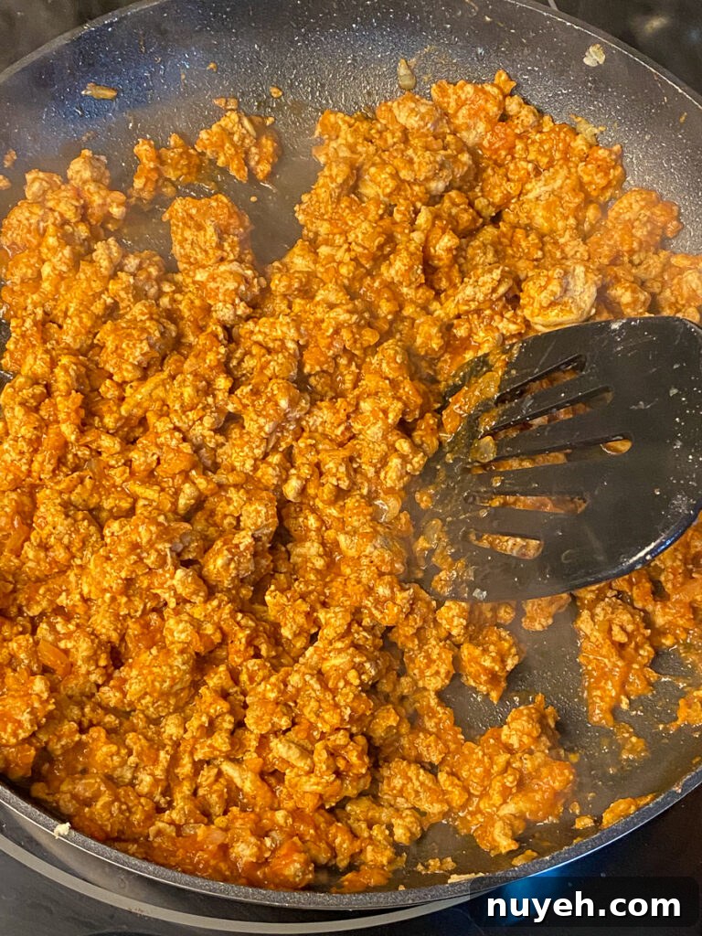 Stirring healthy sloppy jane recipe with a spatula in a skillet