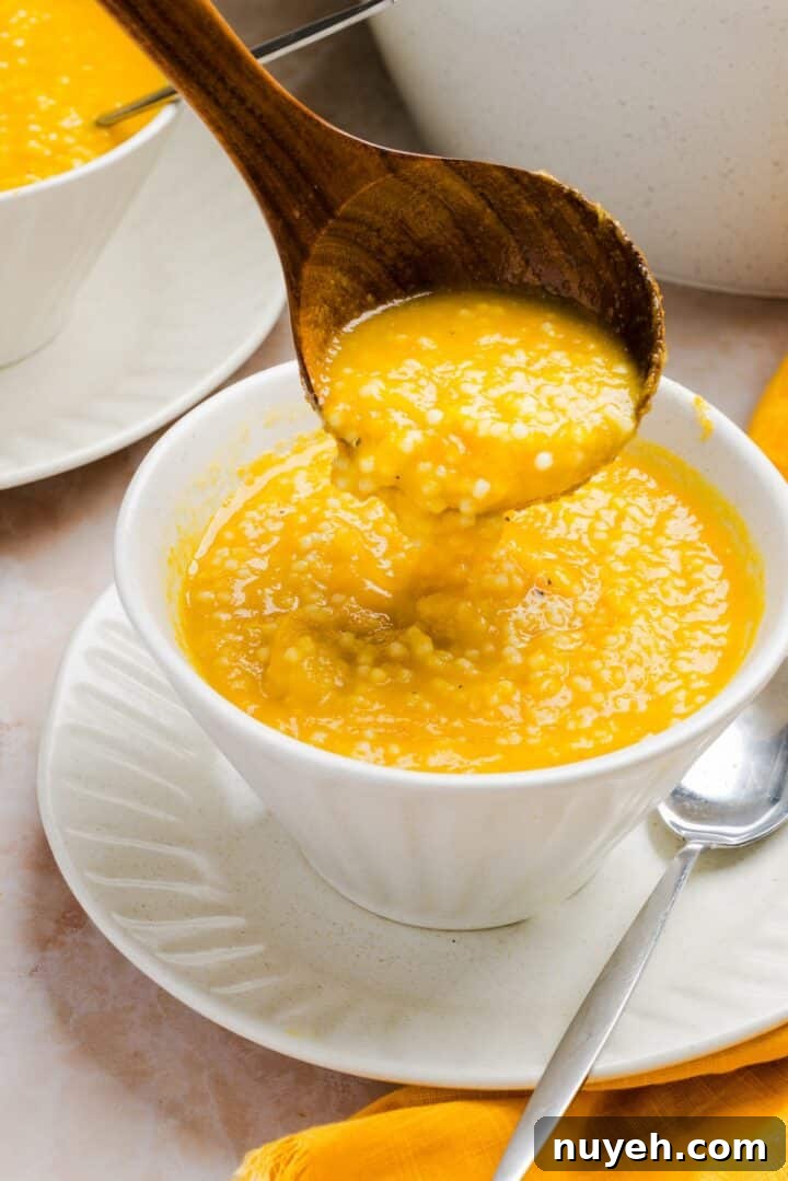 Italian Penicillin Soup being spooned into a white bowl