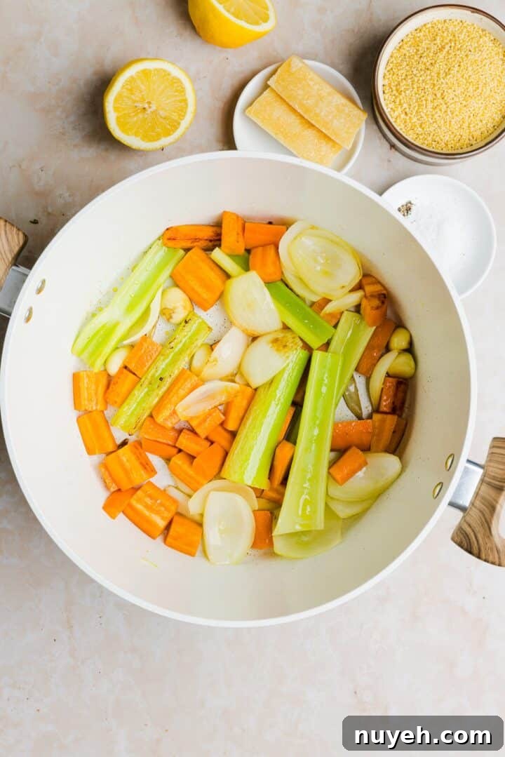 Vegetables for Italian pencillin soup being browned in a large white pot