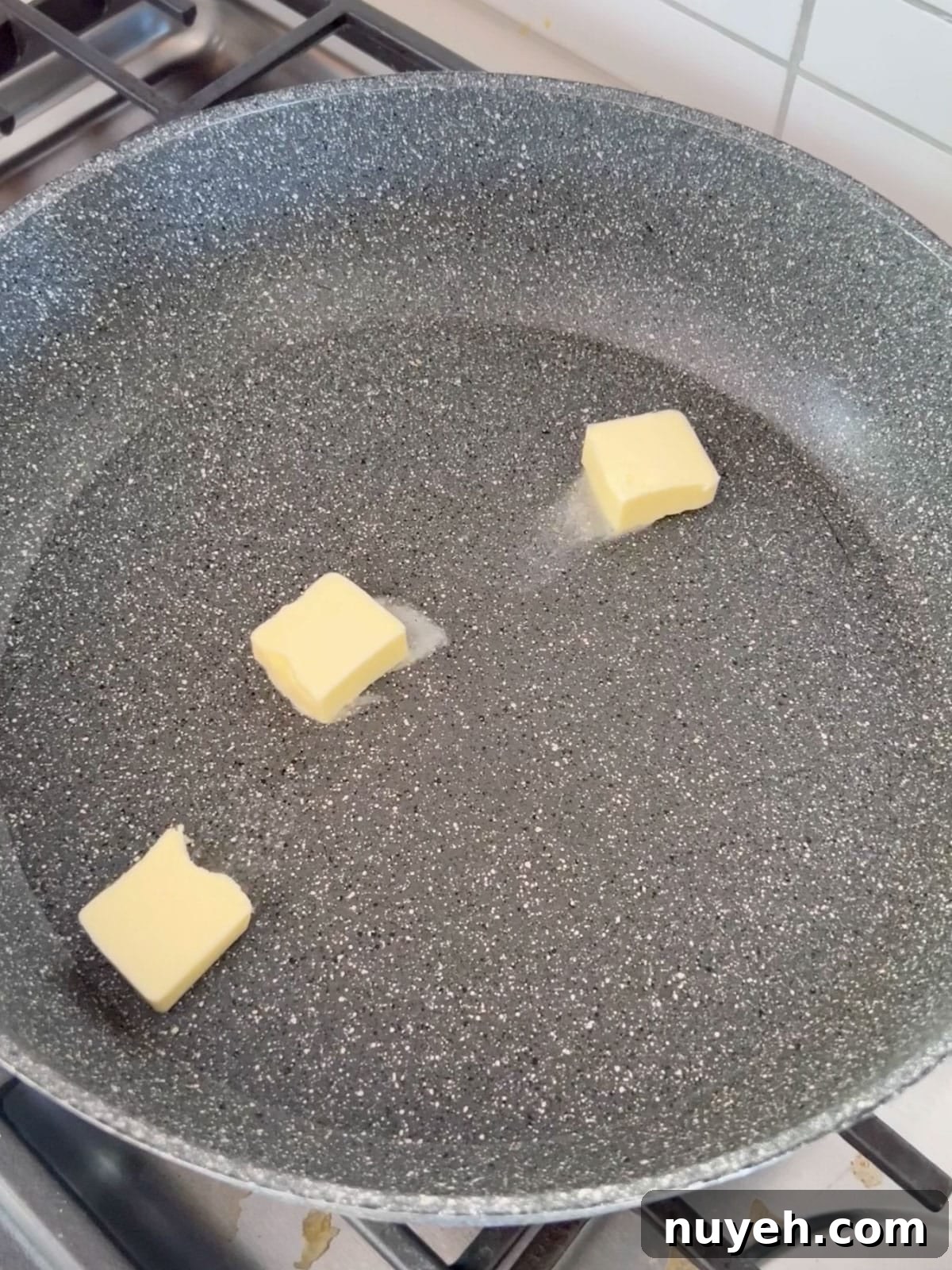 Butter melting in a sauté pan.