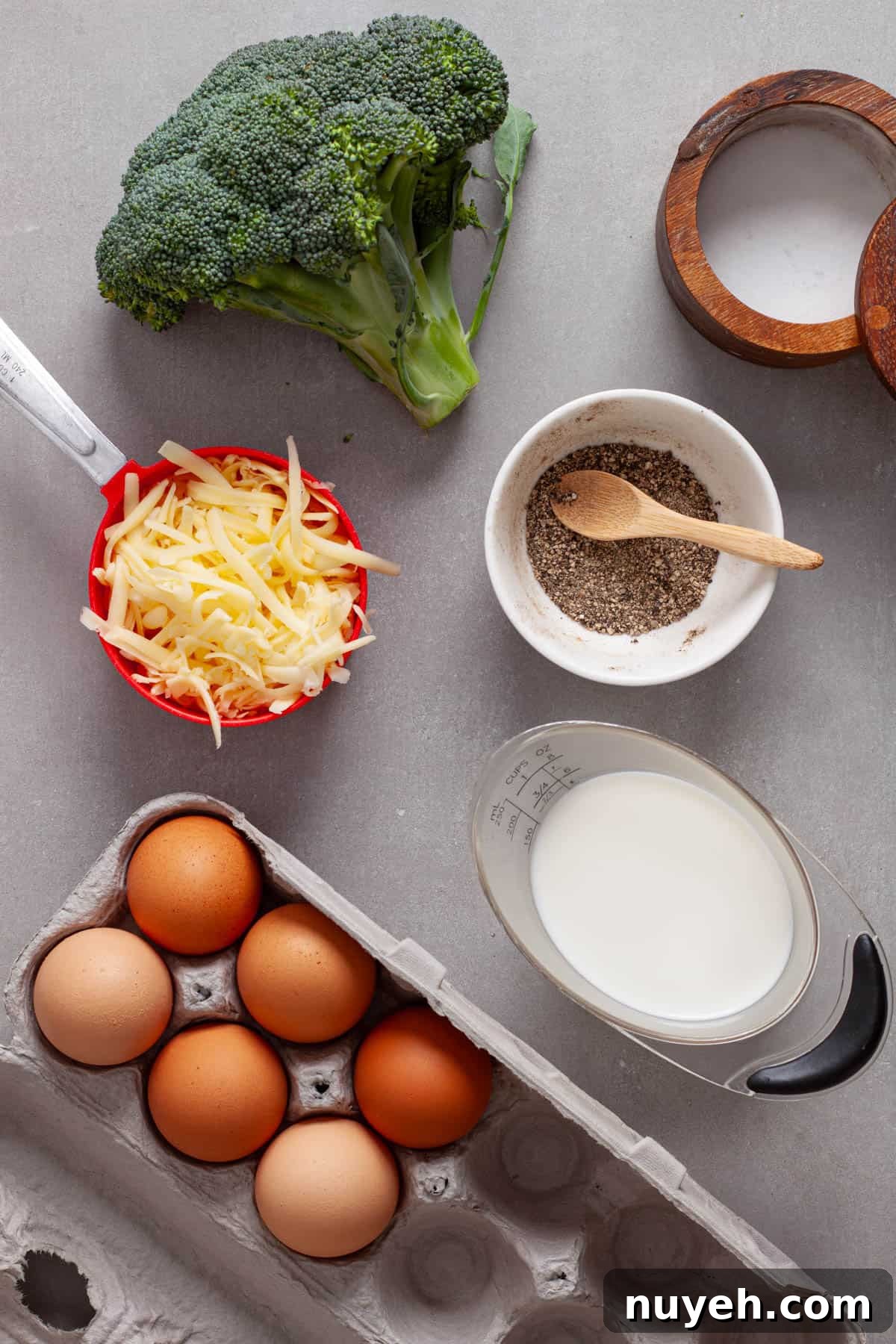 Ingredients for mini egg bites on a gray table.
