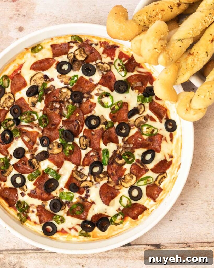 pizza dip with breadsticks.