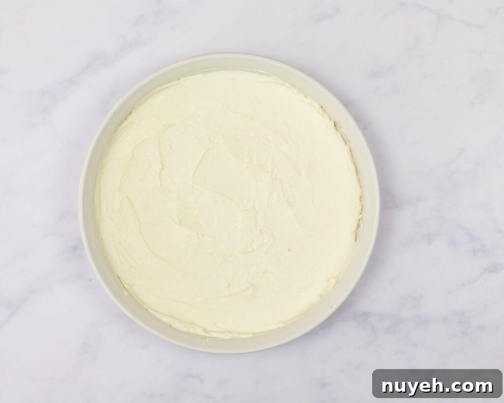 cream cheese base for pizza dip in a pie plate.