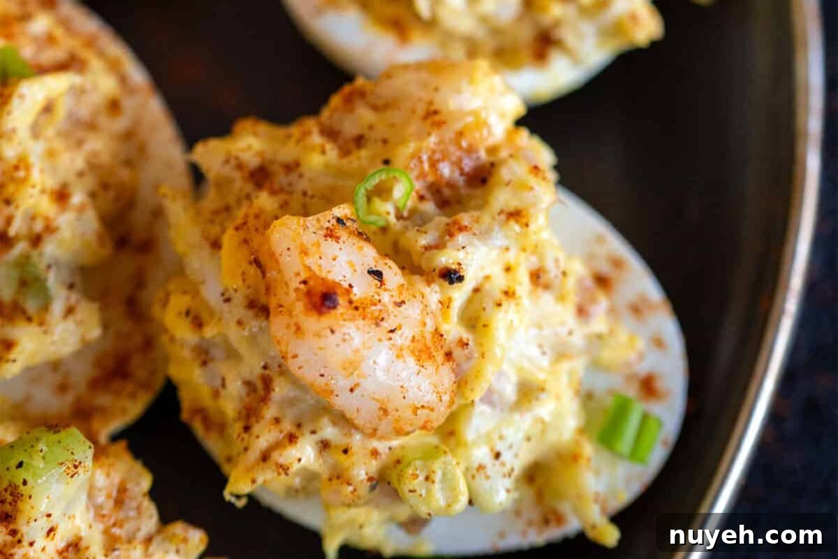 A closeup shot of a plate with several seafood deviled eggs.
