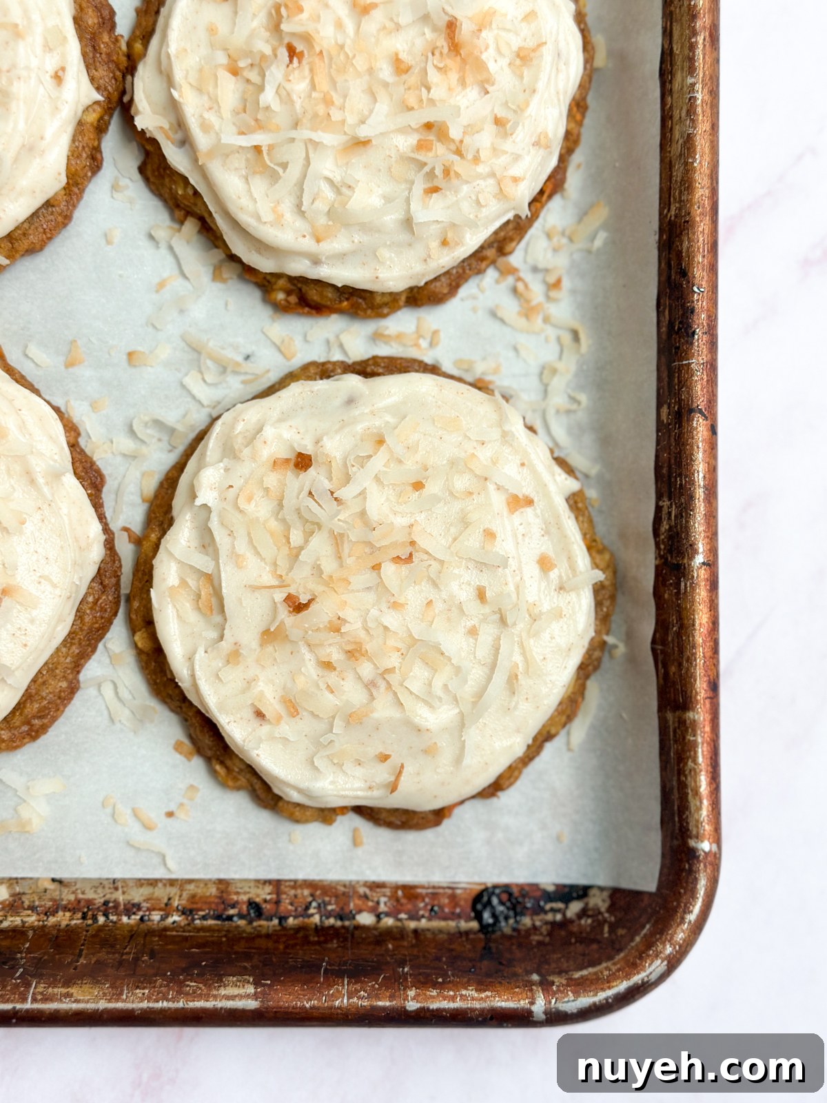 a close up of carrot cake cookies on a cookie sheet.