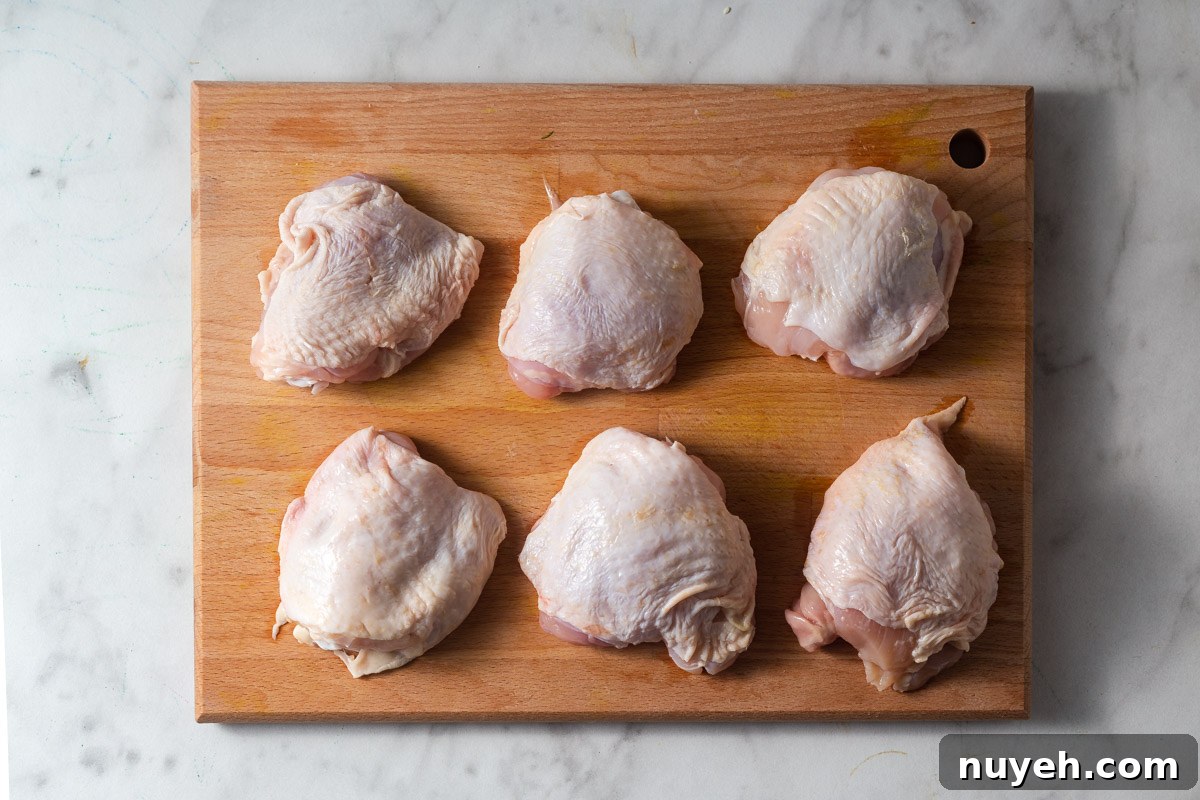 chicken thighs on a chopping board.