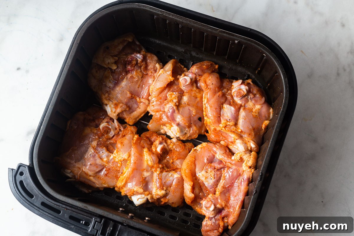 chicken thighs in the air fryer basket.