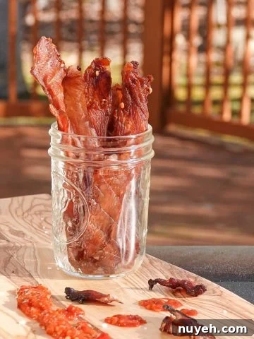 chicken jerky in jar on cutting board