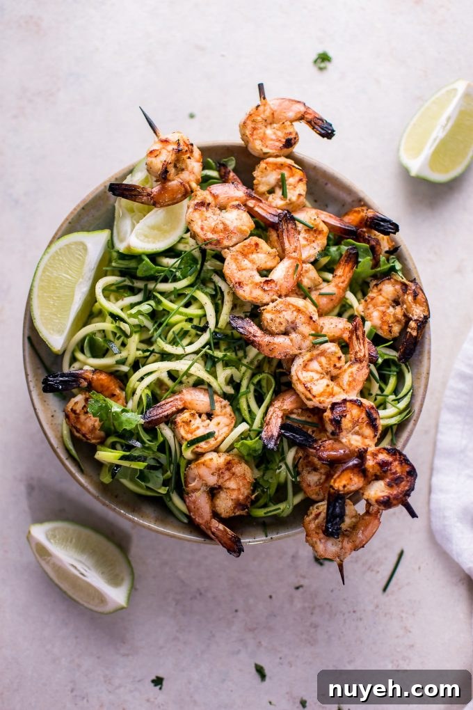 bowl with low-carb grilled chili lime shrimp zoodles and lime wedges