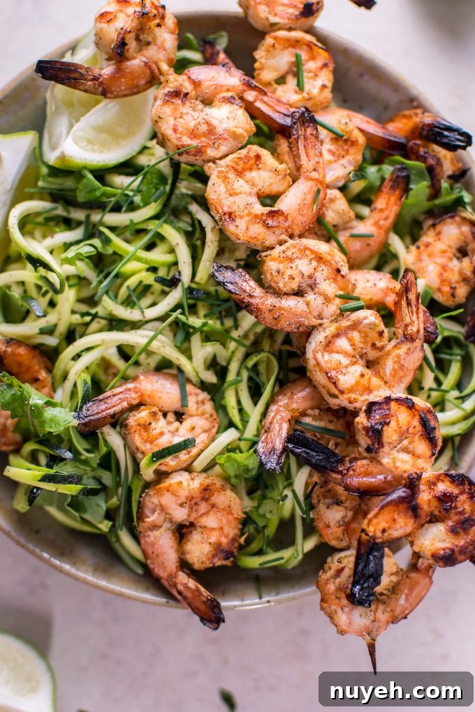 close-up of zucchini noodles with grilled chili lime shrimp