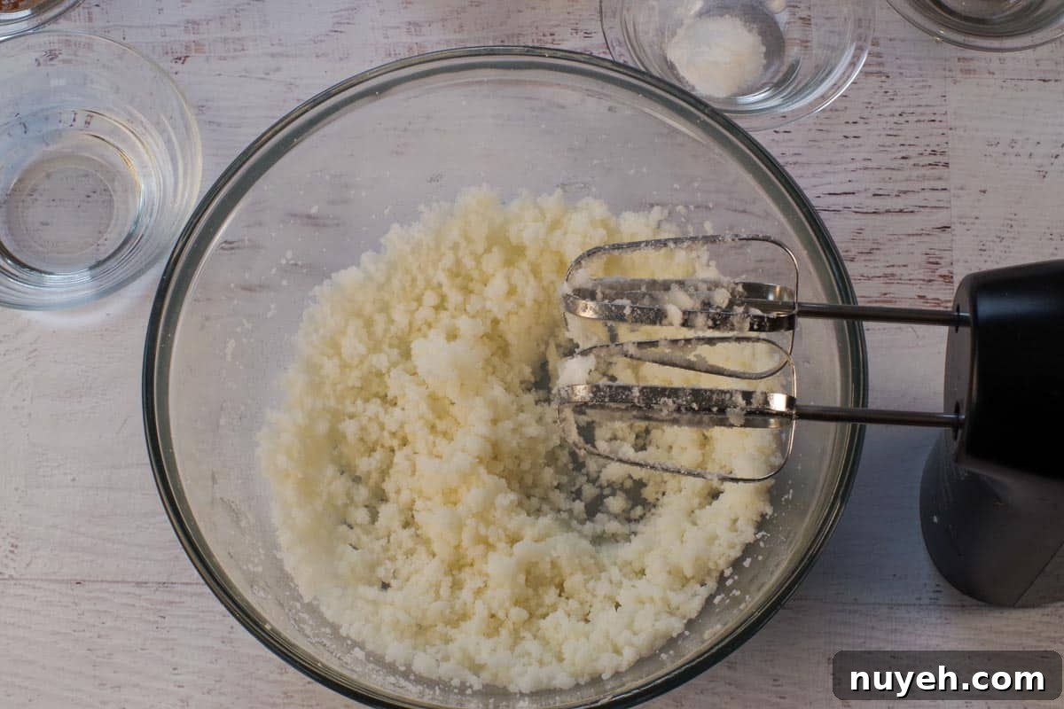 Sugar and shortening beaten together in a large glass bowl.