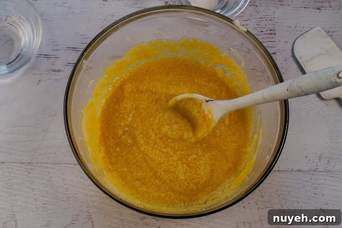 Pumpkin stirred into shortening mixture in large glass bowl.