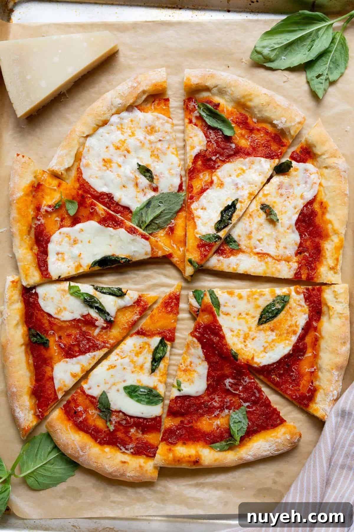 Homemade pizza made with 2-ingredient Greek yogurt pizza dough, topped with marinara, melted mozzarella, and fresh basil.
