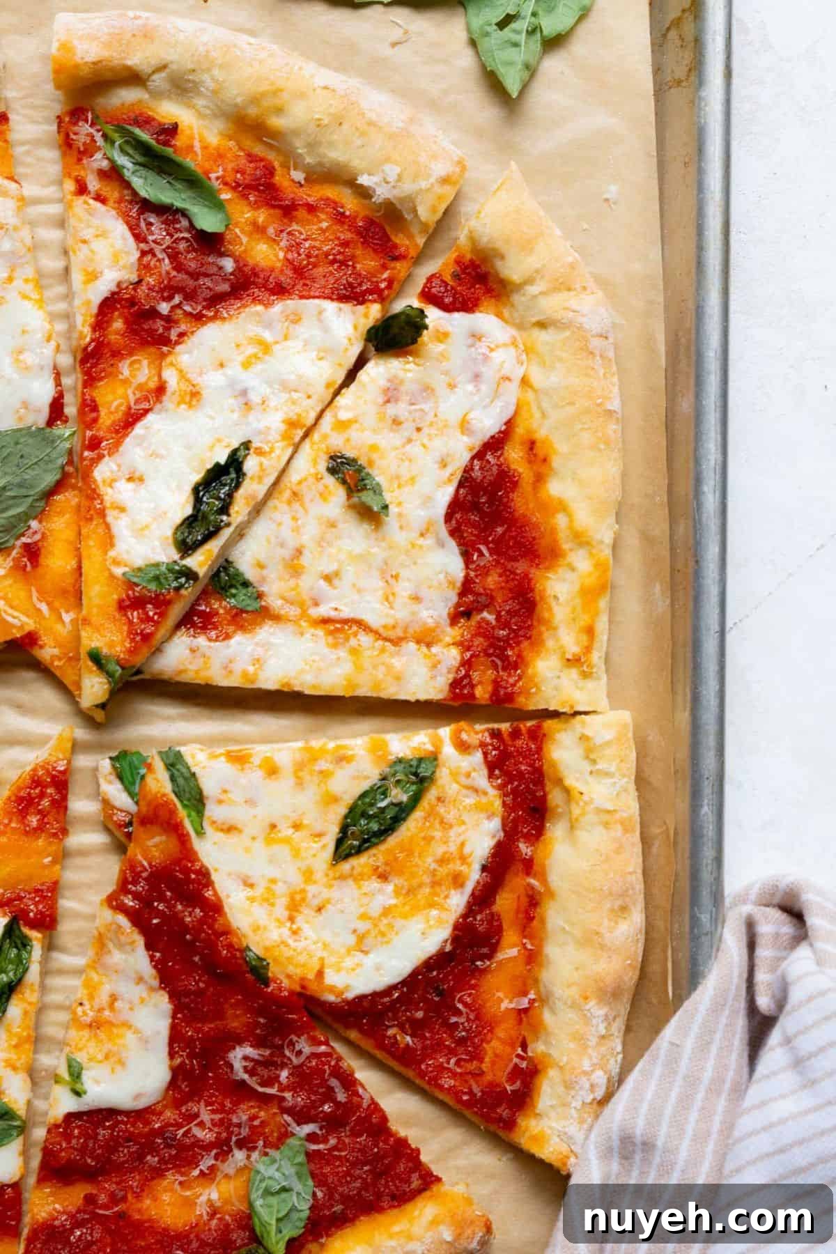 Crispy homemade healthy pizza with melted mozzarella and basil on a soft Greek yogurt pizza crust.