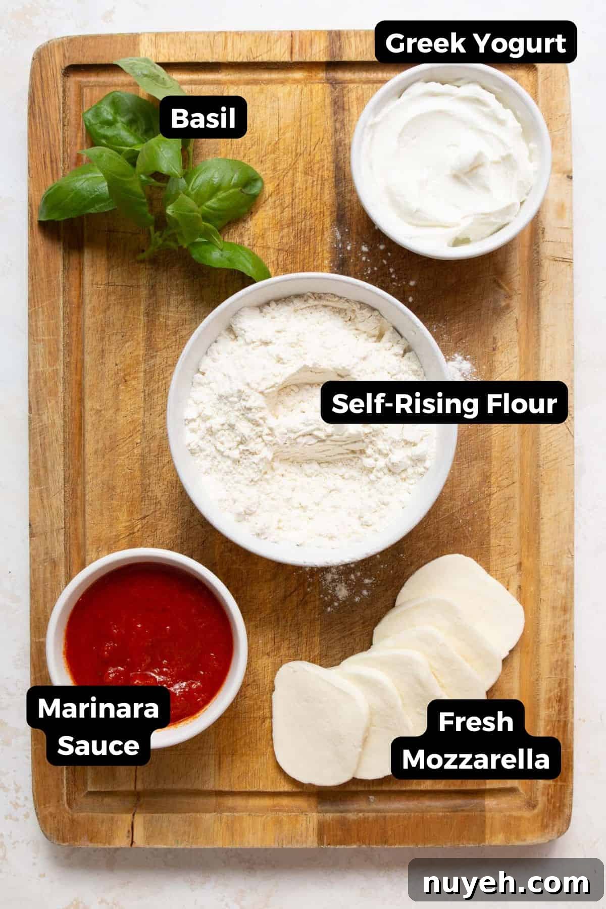 All ingredients in healthy pizza recipe, including: self-rising flour, greek yogurt, basil, marinara sauce, and fresh mozzarella.
